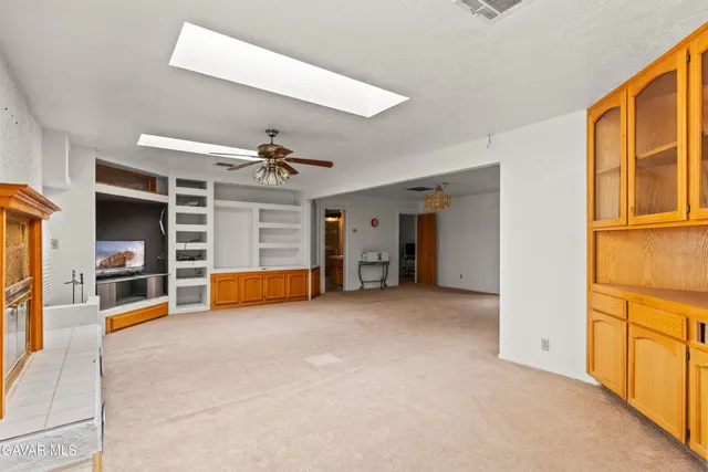 a view of a livingroom with an empty space and a fireplace