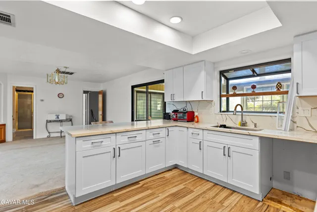 a kitchen with sink and cabinets