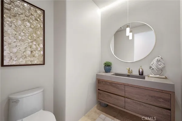 a bathroom with a toilet a sink and a mirror
