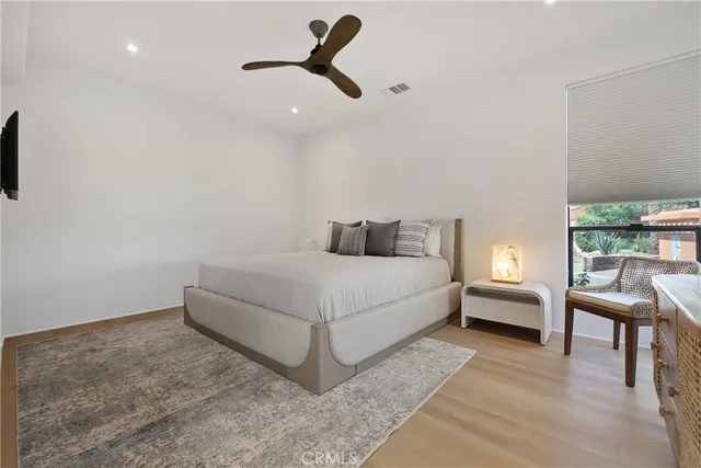 a bedroom with a bed and a chair