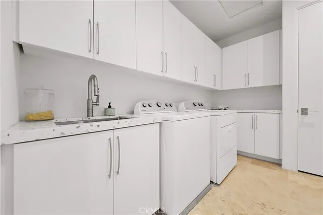 a utility room with sink dryer and washer