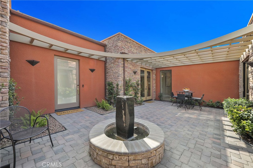 50070 Vía De Moda La Quinta, CA 92253 - Photo 27 of 32 a view of a patio with table and chairs potted plants