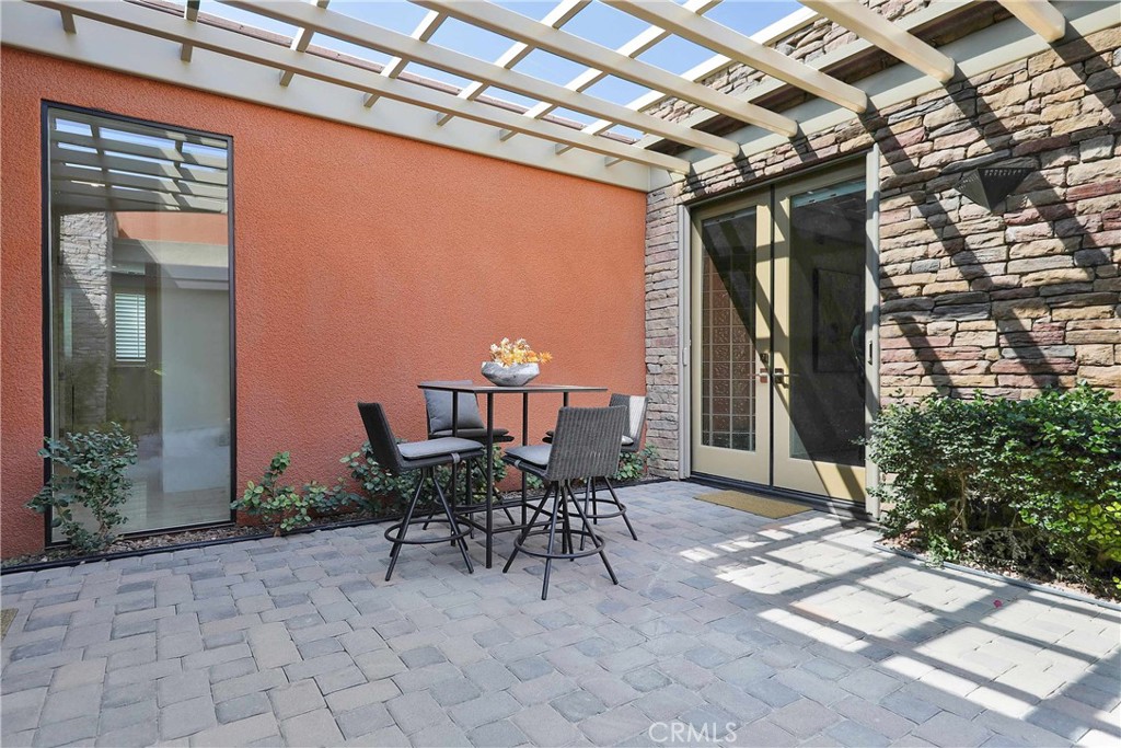 50070 Vía De Moda La Quinta, CA 92253 - Photo 28 of 32 a view of a patio with table and chairs and potted plants