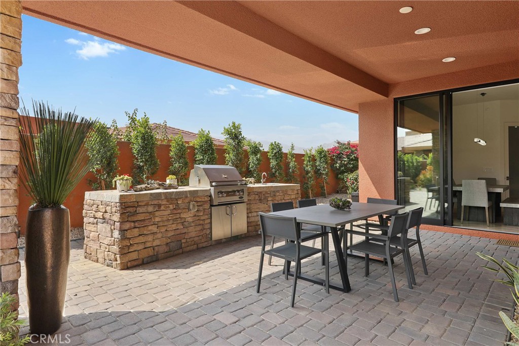 50070 Vía De Moda La Quinta, CA 92253 - Photo 31 of 32 a view of a patio with a table and chairs
