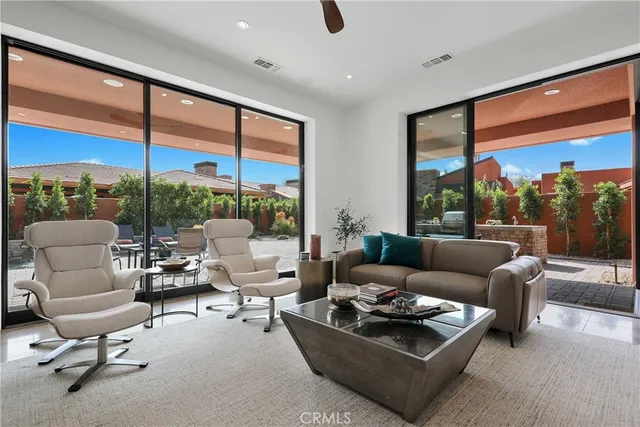 a living room with furniture and floor to ceiling window