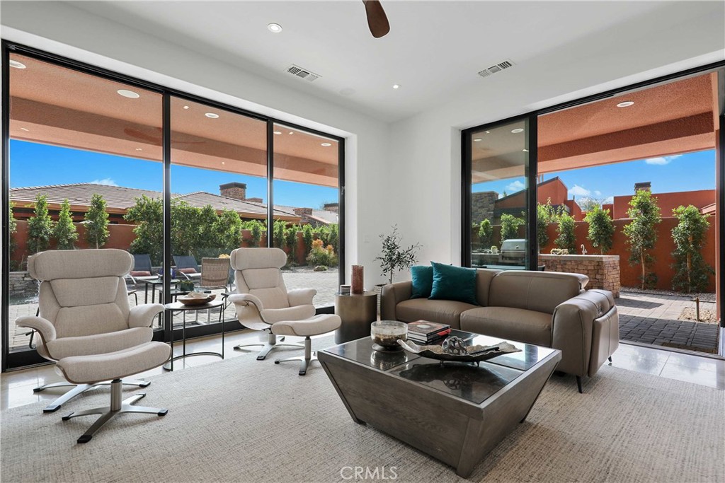 50070 Vía De Moda La Quinta, CA 92253 - Photo 4 of 32 a living room with furniture and floor to ceiling window