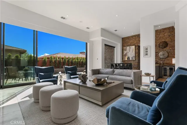 a living room with fireplace furniture and a floor to ceiling window