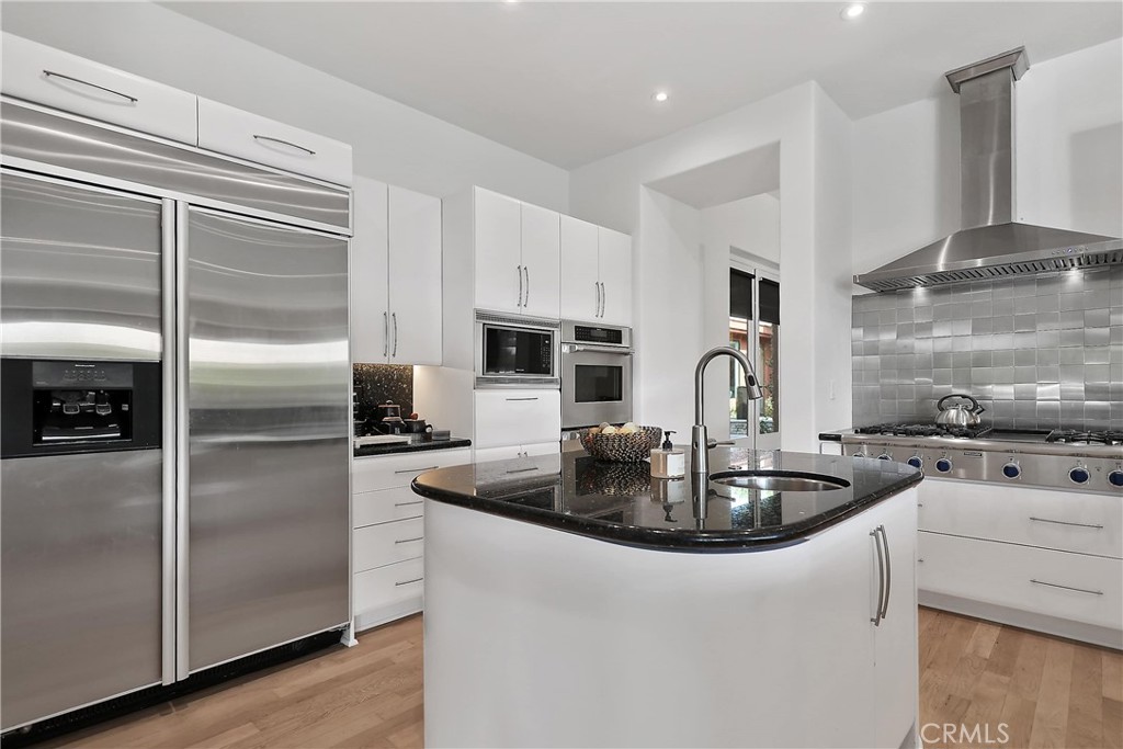 50070 Vía De Moda La Quinta, CA 92253 - Photo 9 of 32 a kitchen with sink a refrigerator and stainless steel appliances