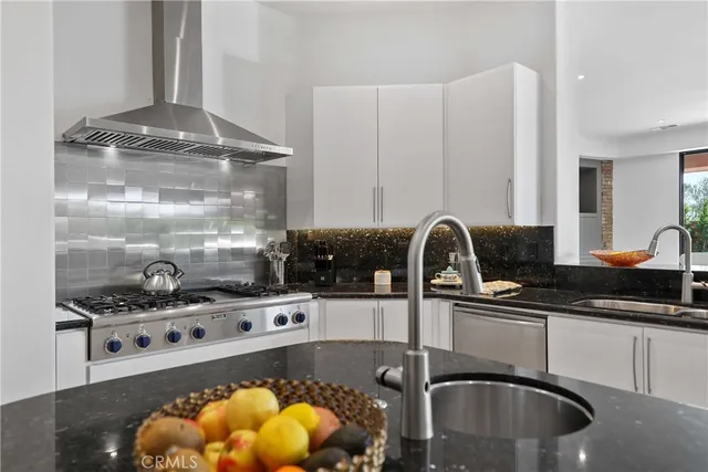 a kitchen with a sink a stove and cabinets
