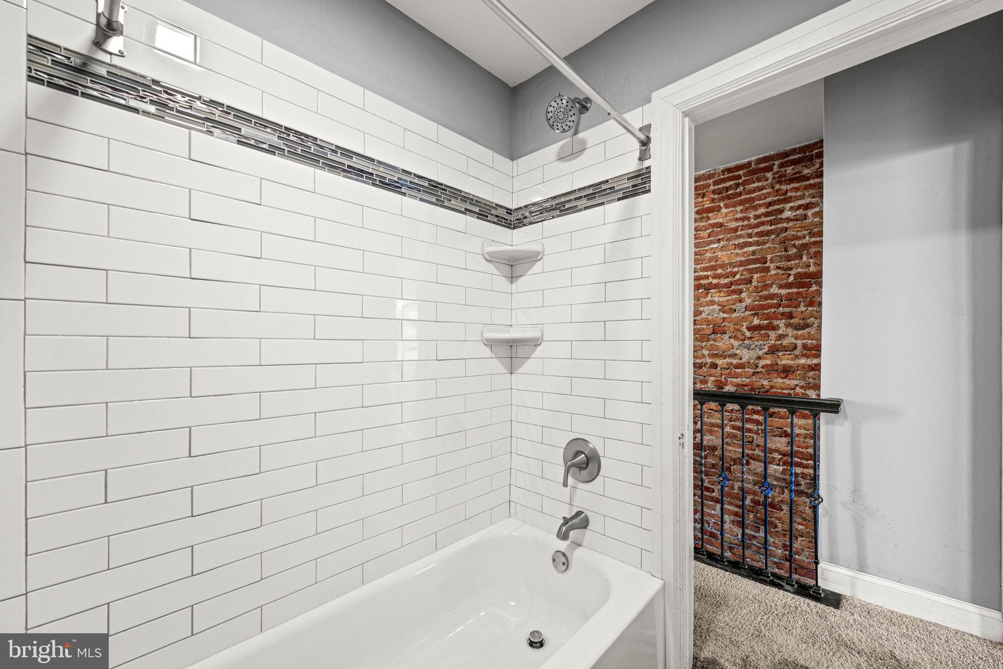 5426 Windsor Street Philadelphia, PA 19143 - Photo 14 of 22 a bathroom with a bathtub and shower