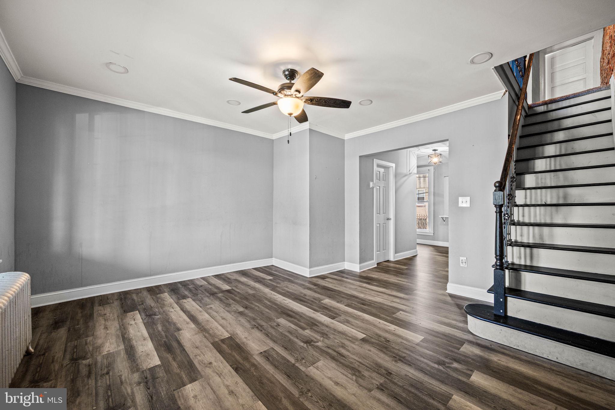 5426 Windsor Street Philadelphia, PA 19143 - Photo 2 of 22 a view of an empty room with wooden floor and a ceiling fan