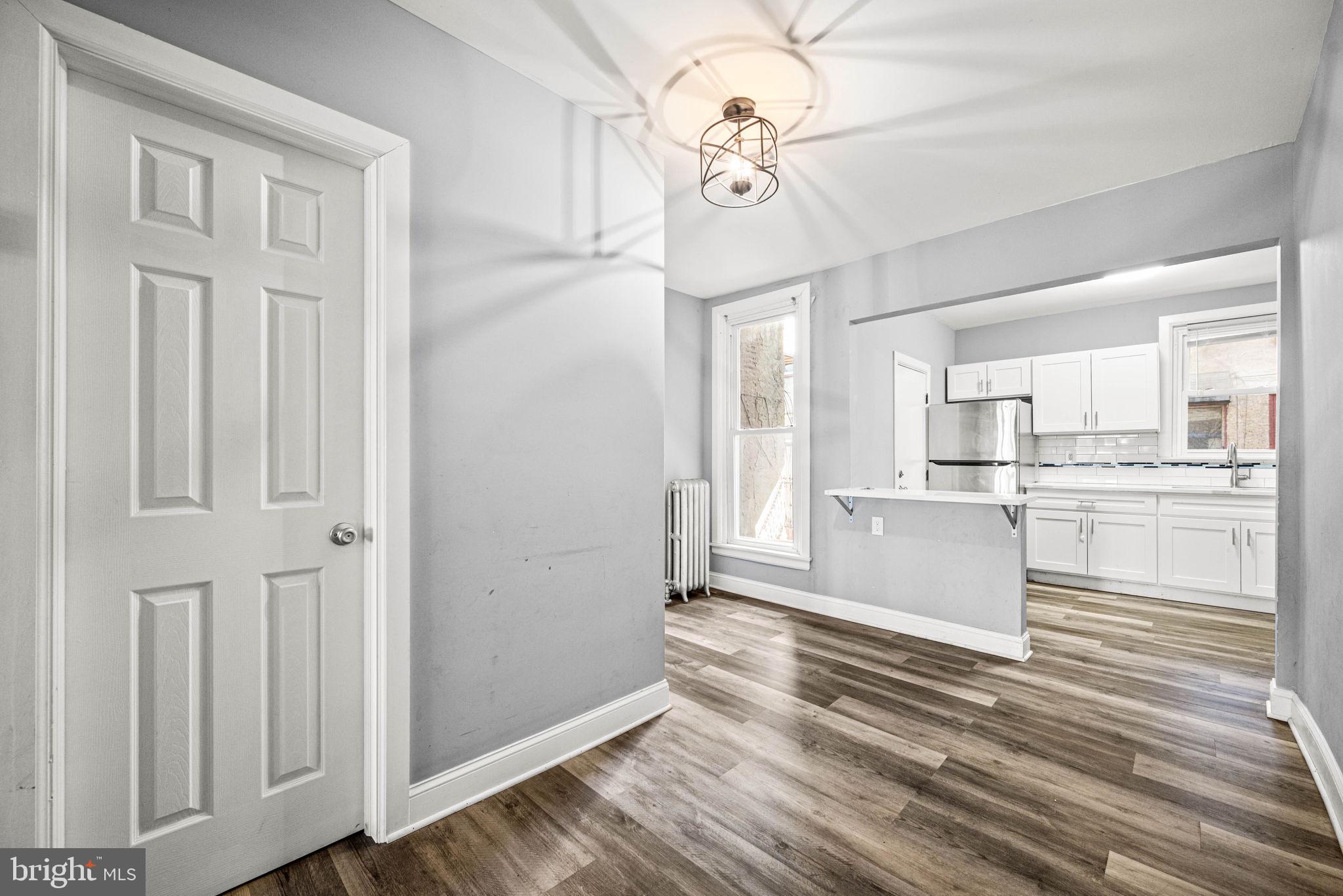 5426 Windsor Street Philadelphia, PA 19143 - Photo 4 of 22 a view of kitchen with cabinets and wooden floor