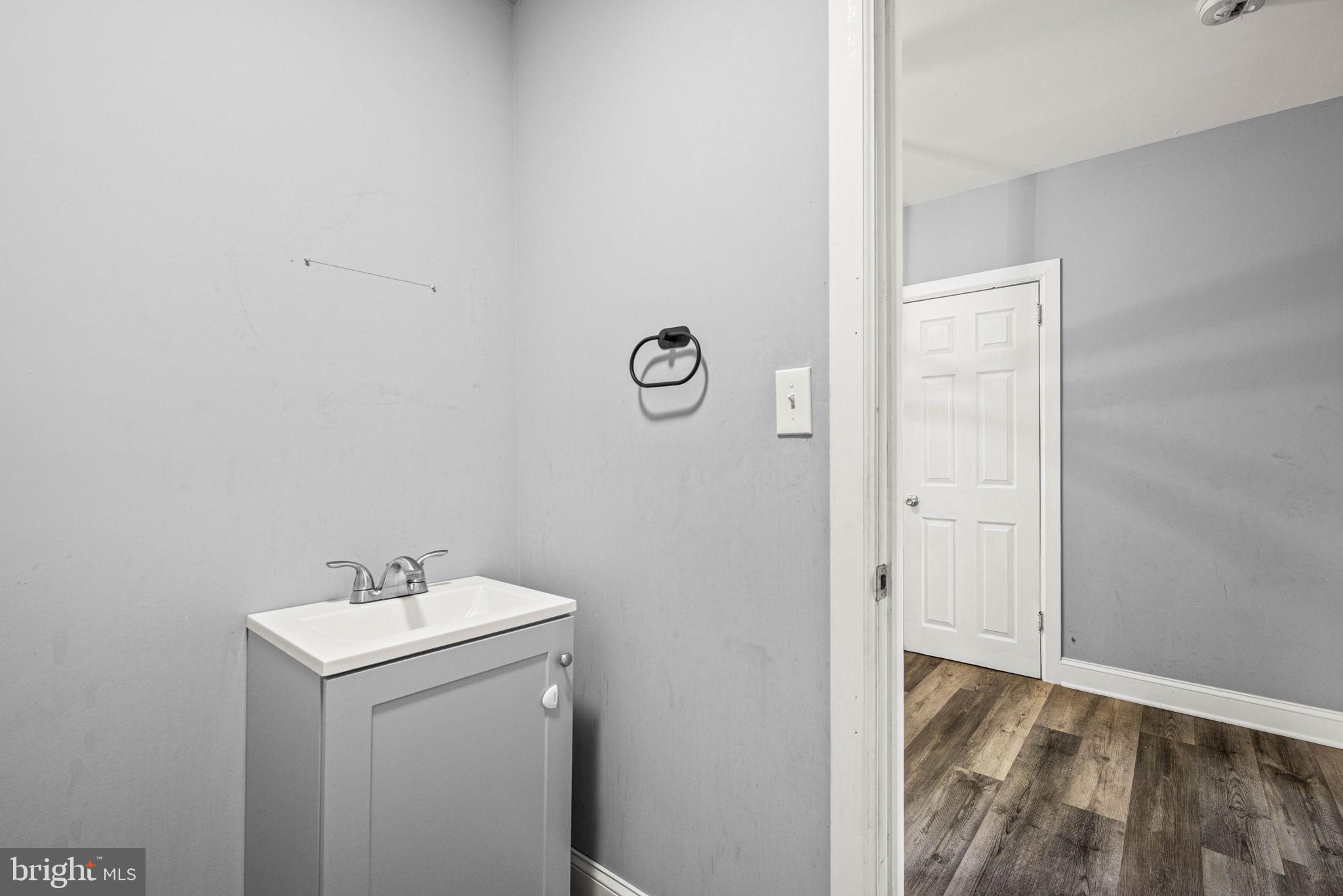 5426 Windsor Street Philadelphia, PA 19143 - Photo 6 of 22 a bathroom with a sink and vanity