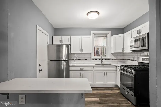 a kitchen with a sink stove and refrigerator