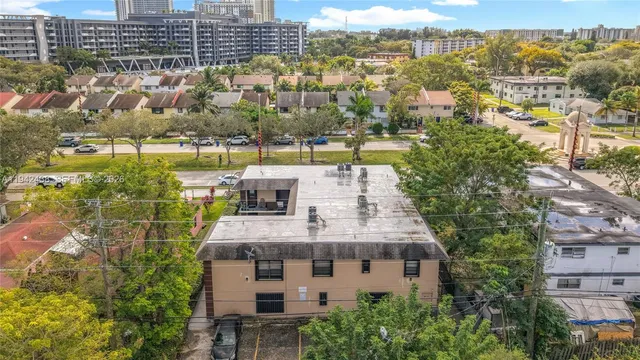an aerial view of residential building with swimming pool and ocean view