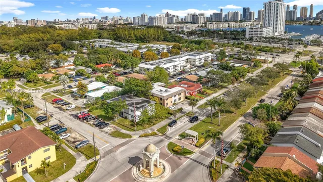 an aerial view of residential houses with city view