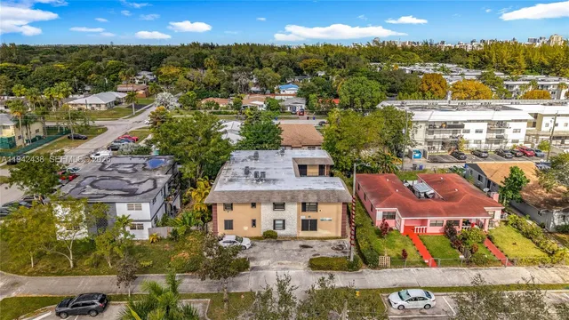 an aerial view of residential houses with outdoor space and city view
