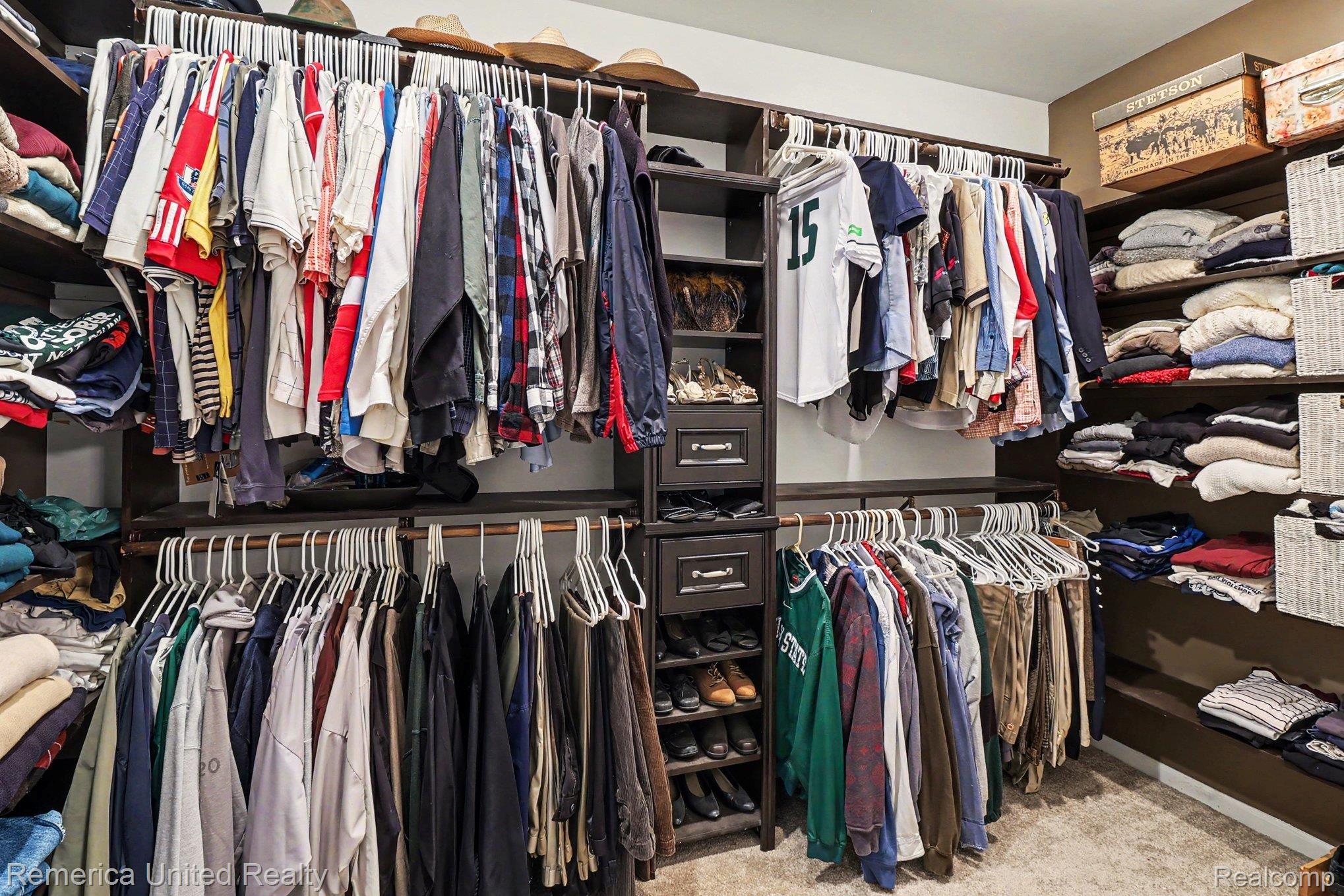 20962 Wasson Road Gregory, MI 48137 - Photo 18 of 39 Custom closet system featuring dark wood-finish shelving and cabinetry with drawer storage