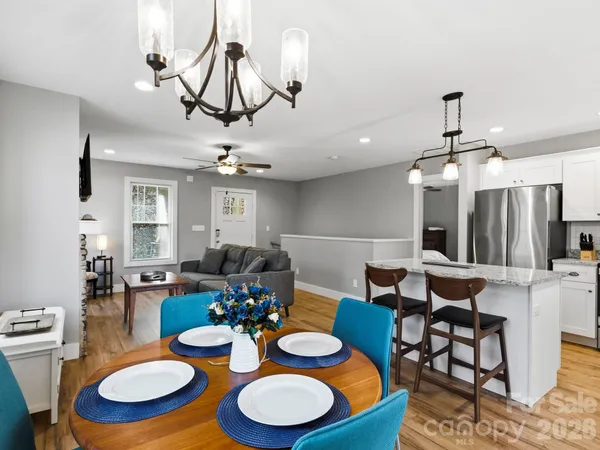 a view of a dining room with furniture wooden floor and chandelier