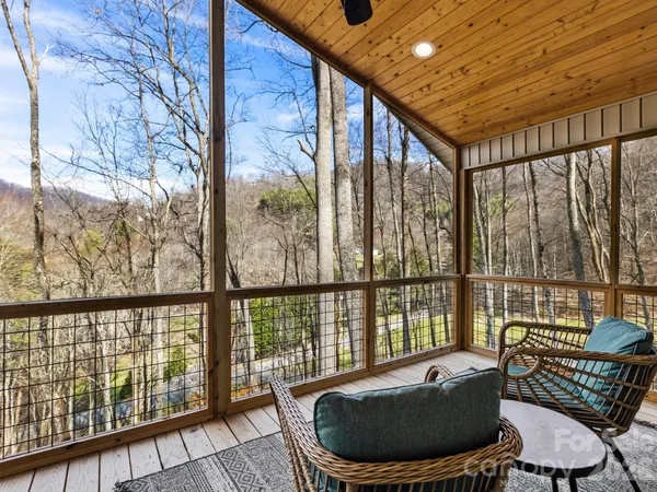 a living room with furniture and a floor to ceiling window