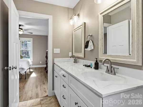 a bathroom with a double vanity sink and a mirror