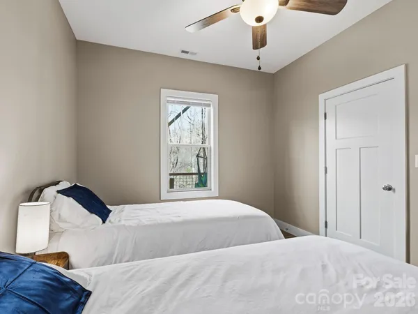 a bedroom with a bed and window