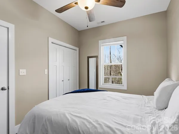 a bedroom with a bed and a window