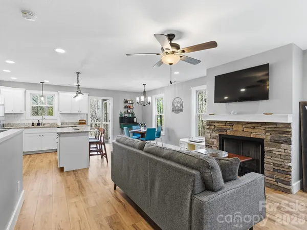 a living room with furniture a flat screen tv and a fireplace