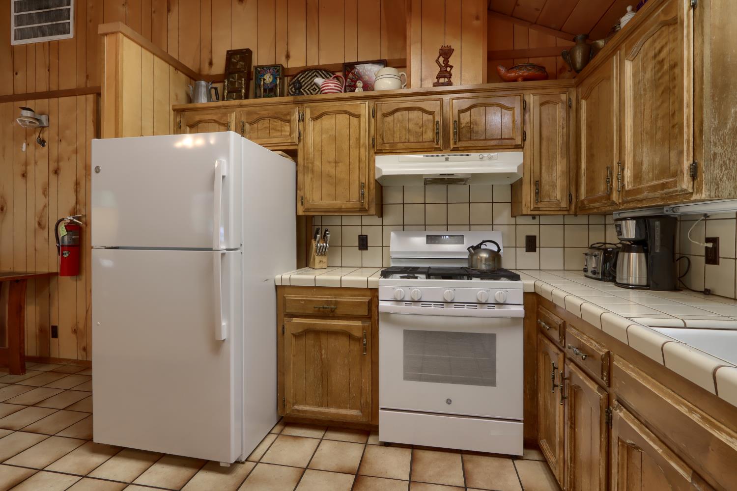 8041 Chilnualna Falls Road Wawona, CA 95389 - Photo 11 of 46 a kitchen with stainless steel appliances granite countertop a refrigerator and a stove