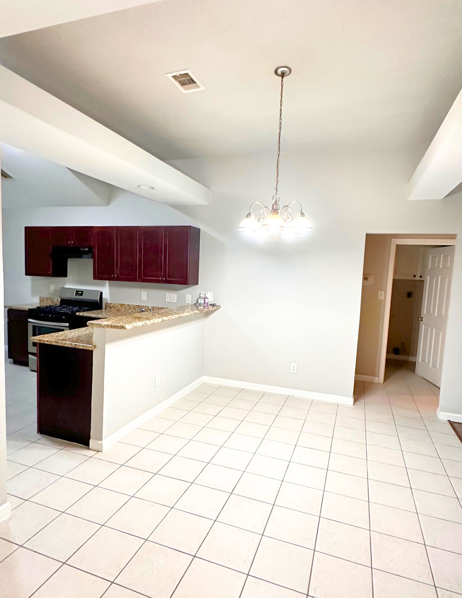 22707 Bridgewater Drive Spring, TX 77373 - Photo 5 of 11 a kitchen with stainless steel appliances kitchen island granite countertop a refrigerator and a sink