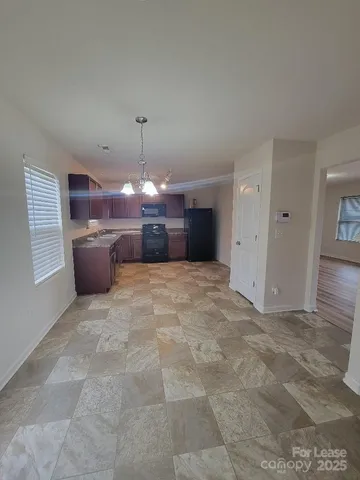 a view of a kitchen with a sink and cabinets