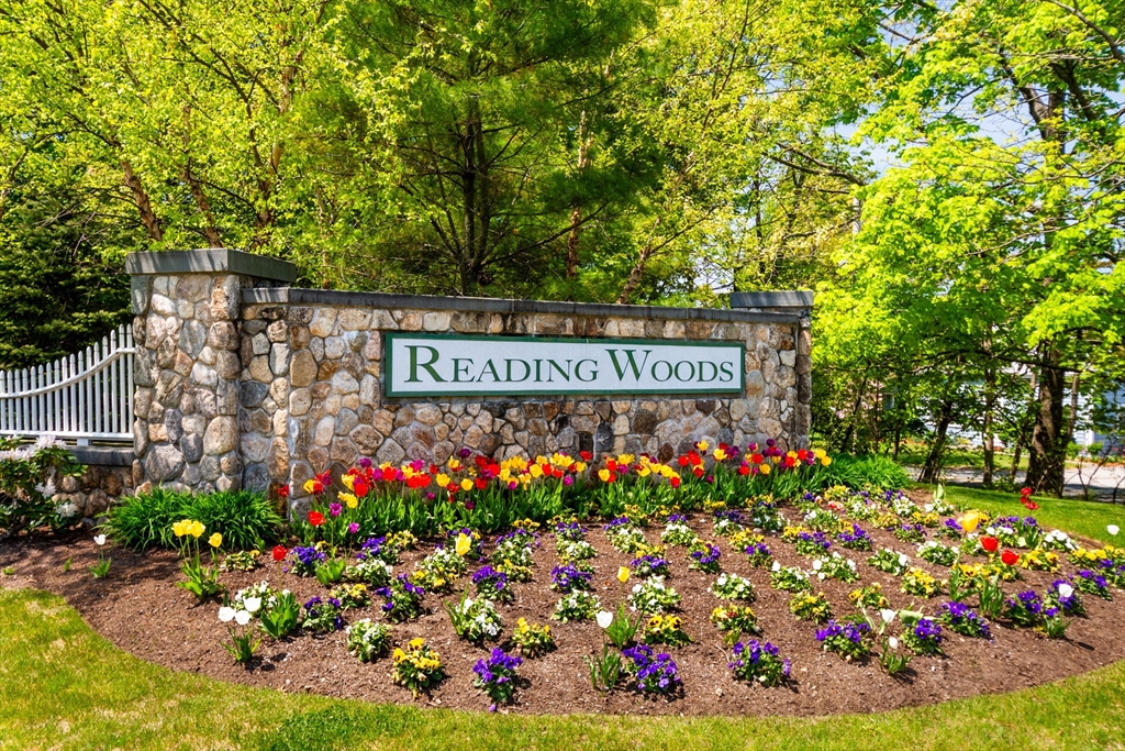 a view of sign board and flowers in yard