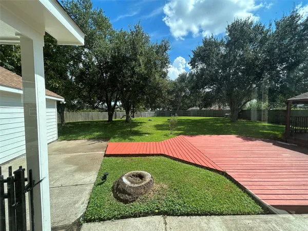 a view of a backyard with swimming pool