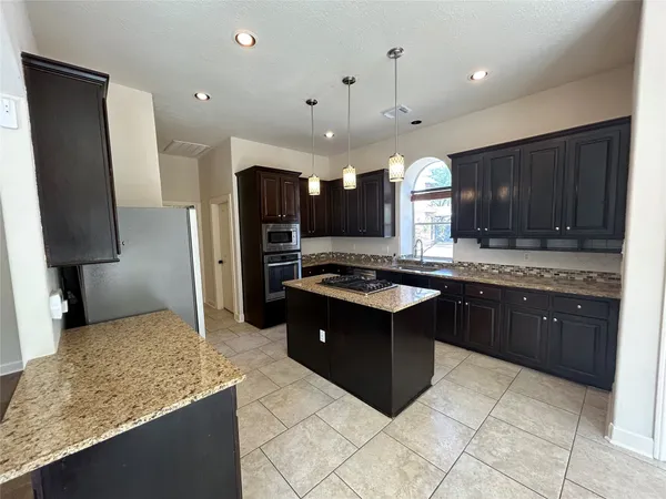 a kitchen with a sink stainless steel appliances and cabinets