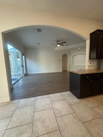 a view of a livingroom with wooden floor and a ceiling fan