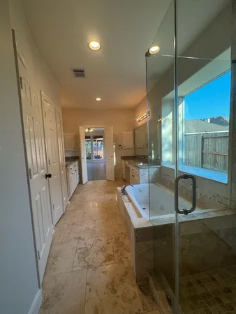 a large bathroom with sinks in shower and mirror