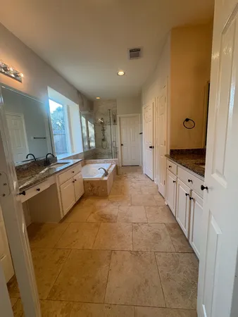 a bathroom with a sink a vanity and a window