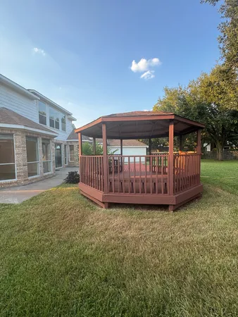 a view of a house with a yard and deck