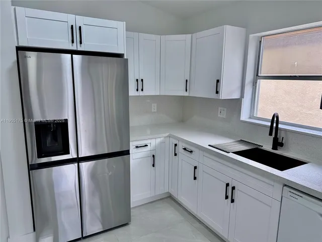 a kitchen with a refrigerator and a sink