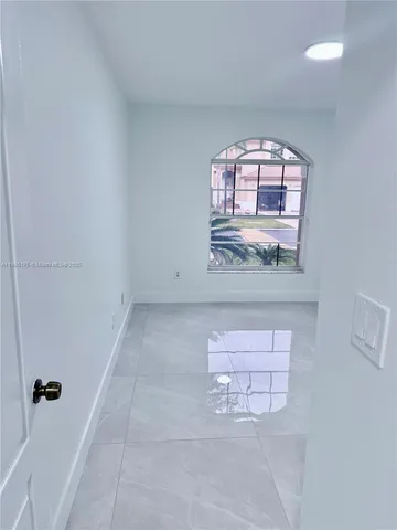 a bathroom with a toilet sink vanity tub and mirror