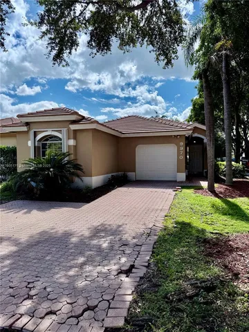 a front view of house with yard and trees
