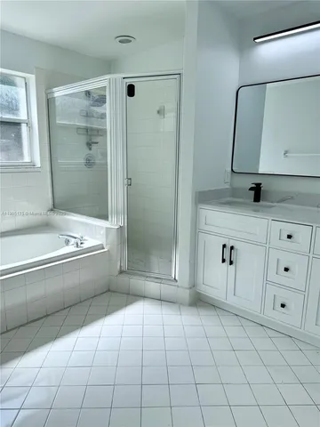 a white toilet sitting next to a shower