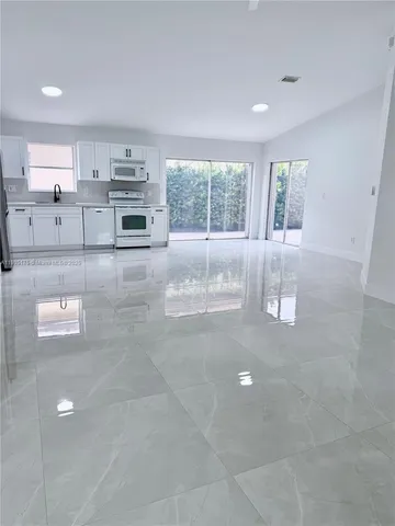 a view of kitchen with stainless steel appliances cabinets