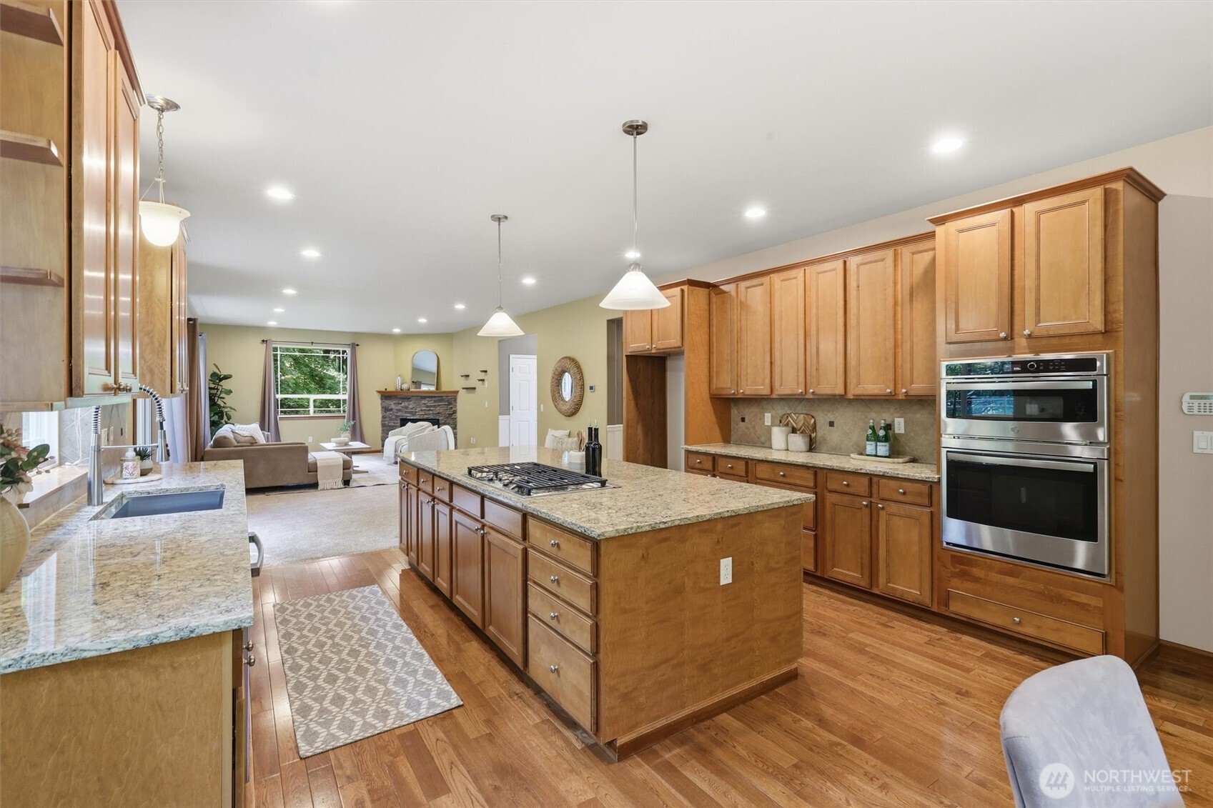 4202 Silvana Terrace Road Stanwood, WA 98292 - Photo 22 of 40 a kitchen with stainless steel appliances granite countertop a stove oven and a refrigerator with cabinets