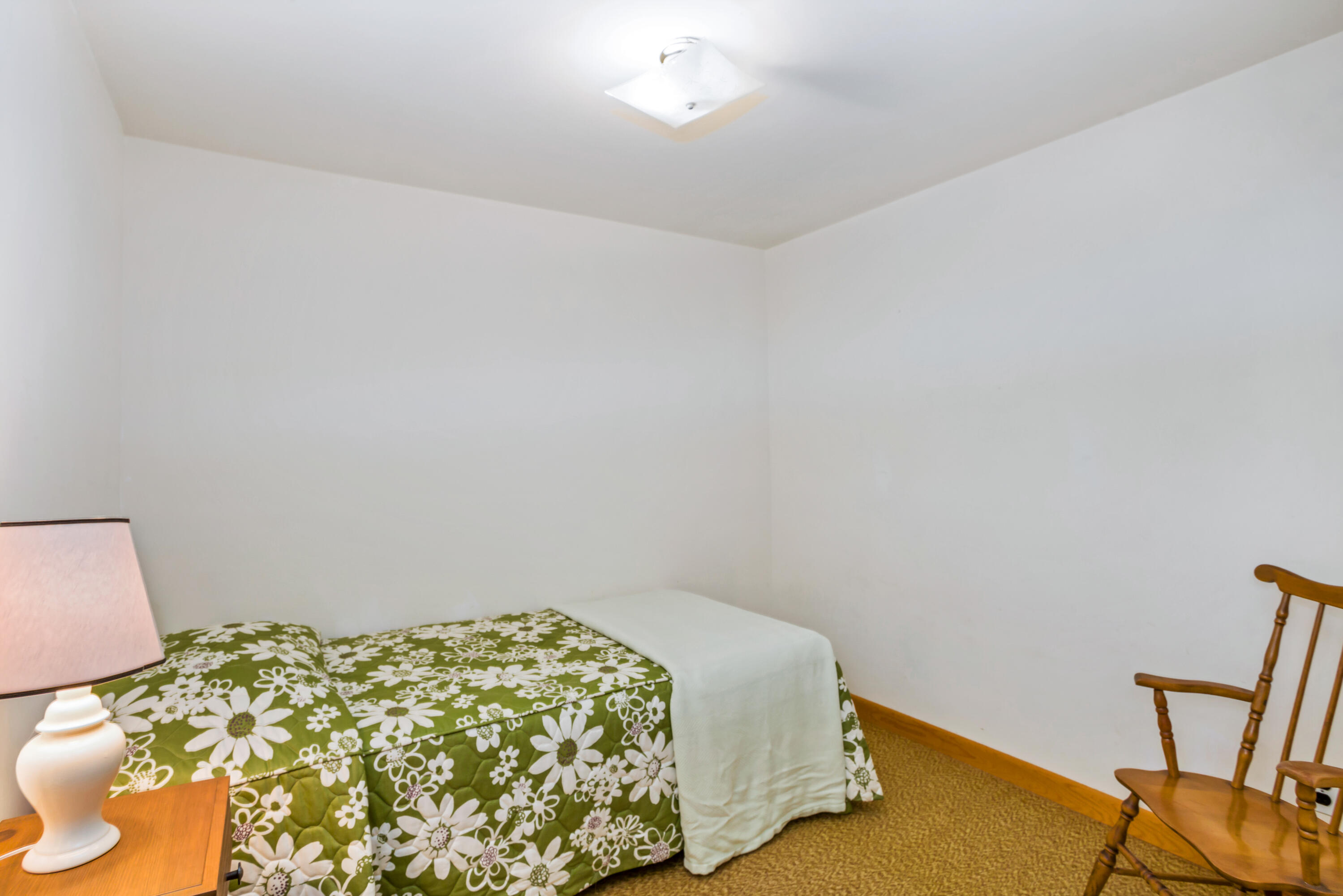 77 Susan Ruth Road Dennis Port, MA 02639 - Photo 18 of 25 a bedroom with a bed and a chair