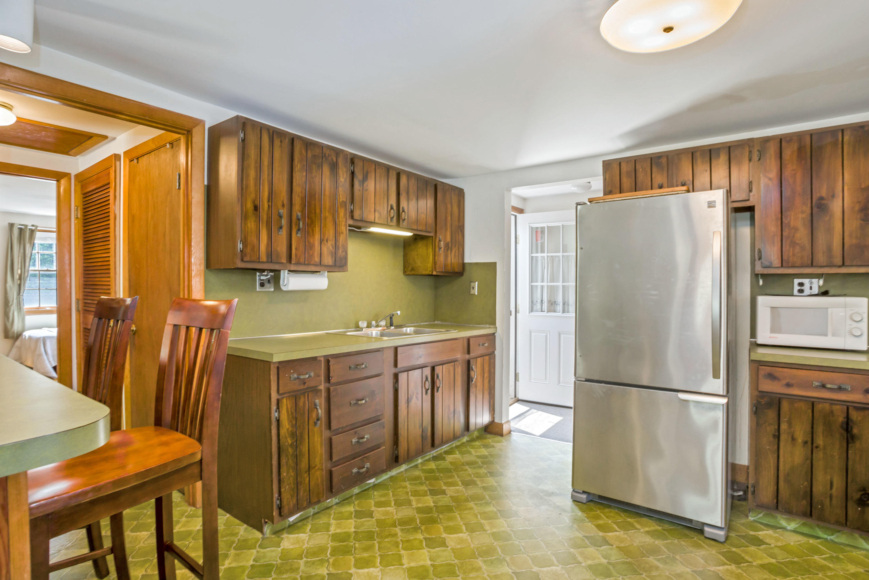 77 Susan Ruth Road Dennis Port, MA 02639 - Photo 9 of 25 a kitchen with stainless steel appliances granite countertop a refrigerator a stove and a sink with granite countertops
