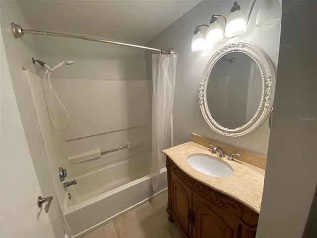a bathroom with a granite countertop sink toilet and a mirror