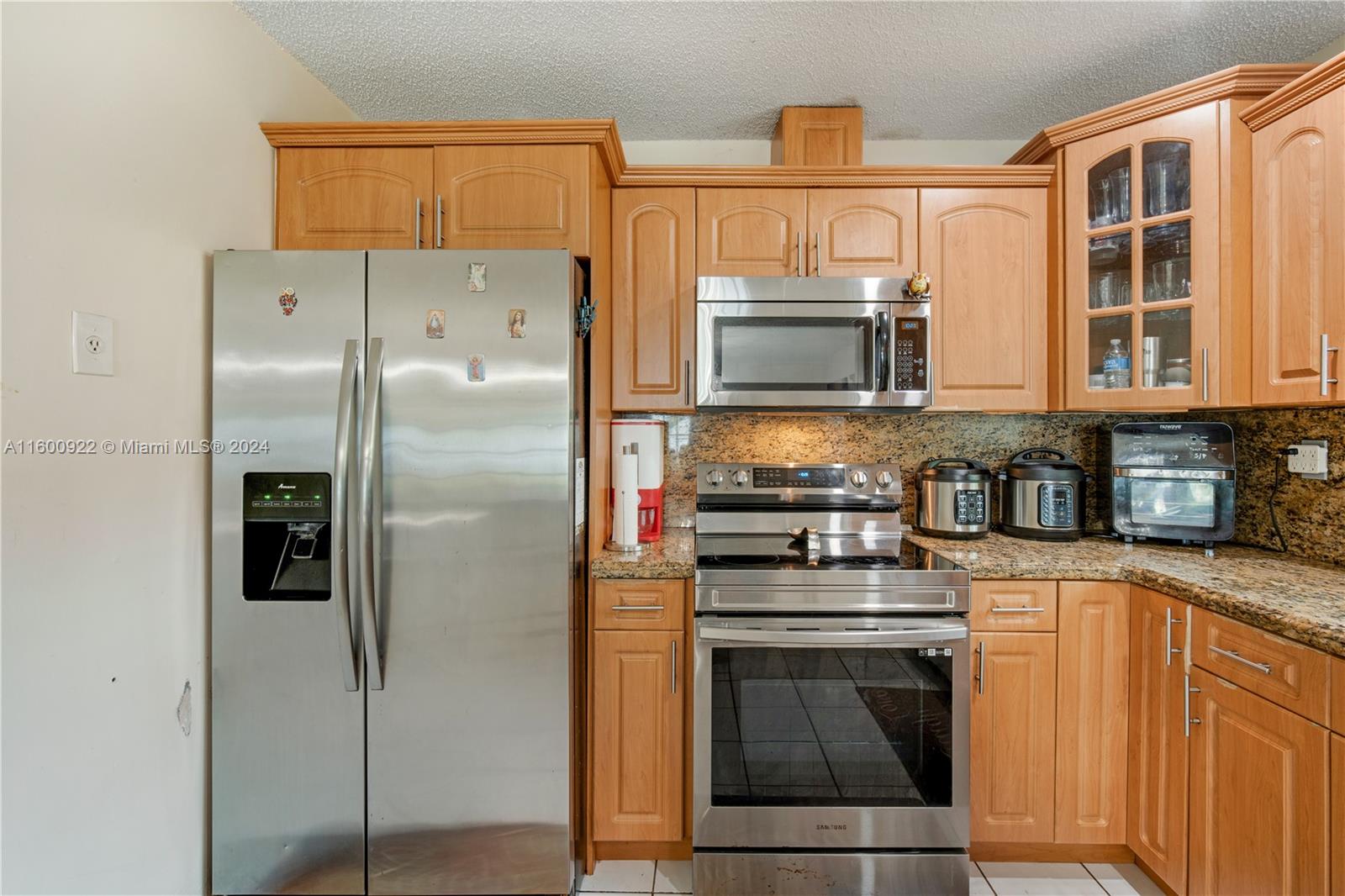 2245 Southwest 62nd Avenue Miami, FL 33155 - Photo 12 of 35 a kitchen with stainless steel appliances granite countertop a stove a refrigerator and a microwave
