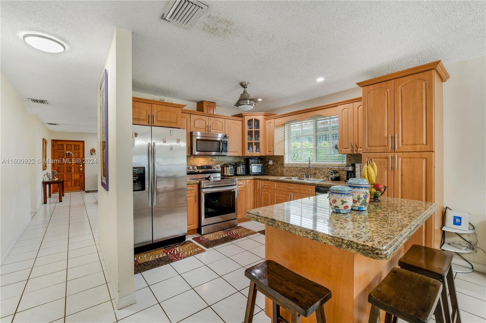 2245 Southwest 62nd Avenue Miami, FL 33155 - Photo 15 of 35 a kitchen with granite countertop a refrigerator and a stove top oven