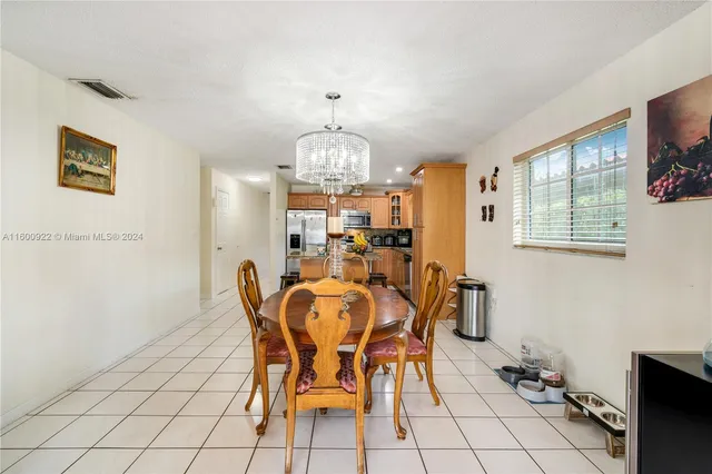 a view of a dining room with furniture and chandelier